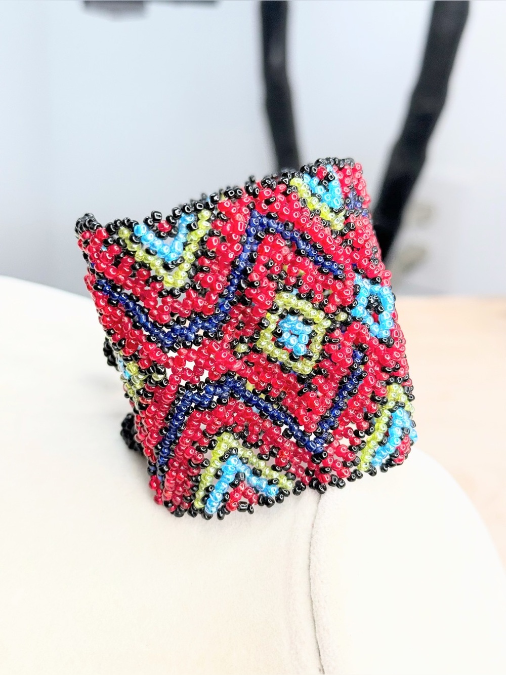 Bold handcrafted-style seed bead cuff bracelet featuring an intricate geometric